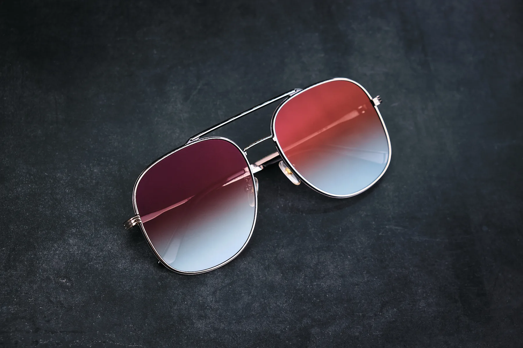 Kolari Shades aviators with gradient lenses on a dark surface