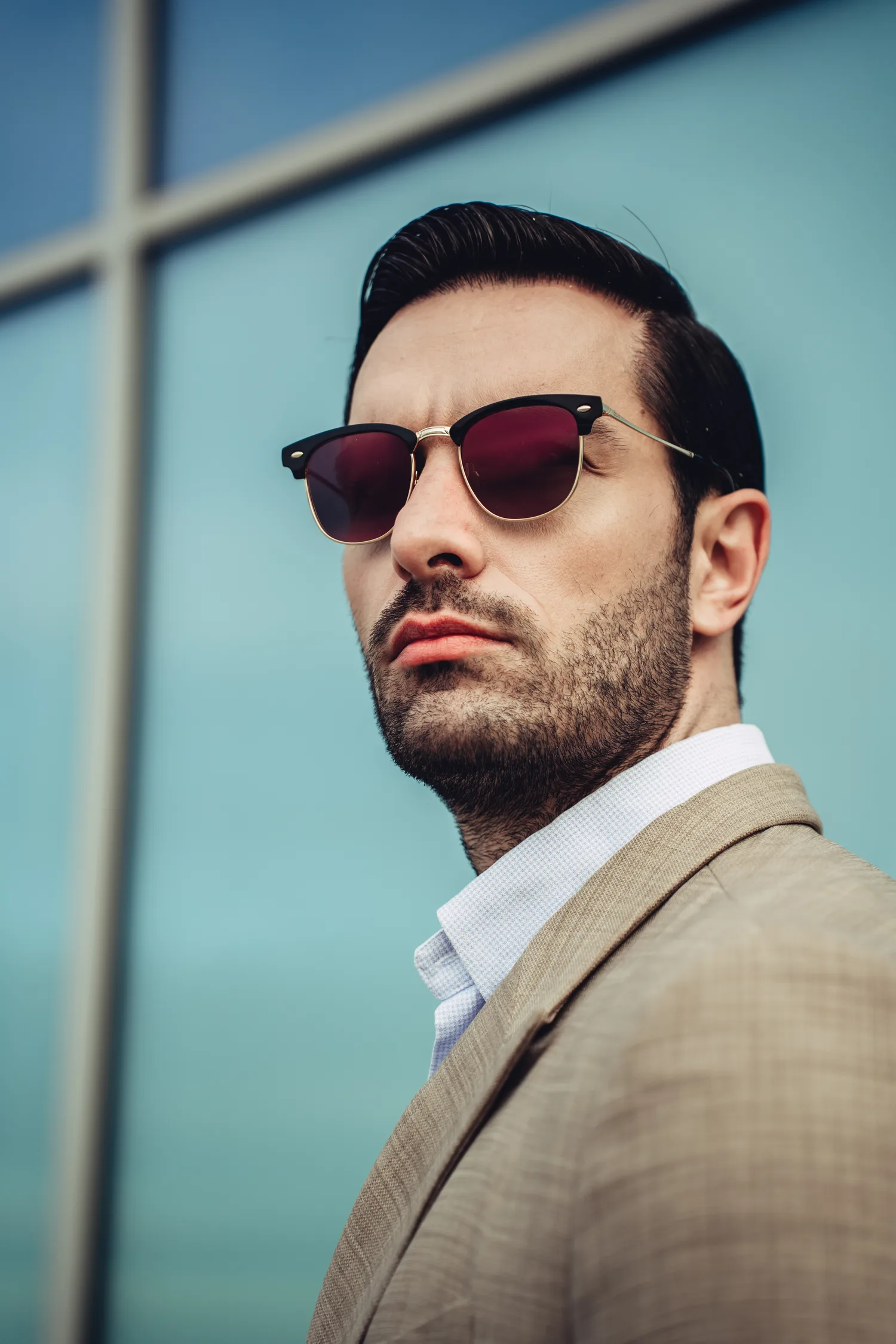 A person wearing Kolari Shades aviators in a city setting
